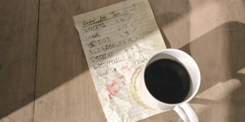 Smudged and messy handwritten order with a coffee mug Smudged and messy handwritten order with a coffee mug